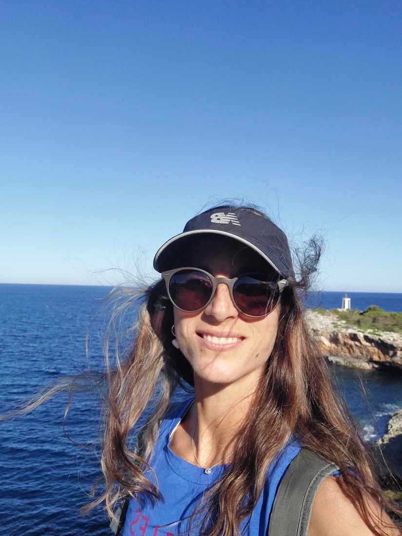 Camila smiling by the sea on the Mallorca coast